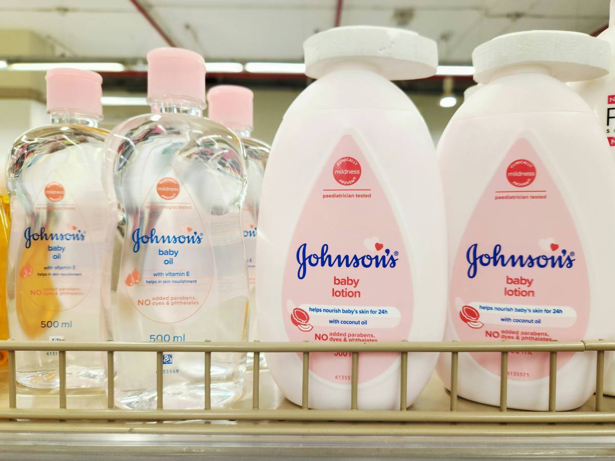 close-up of non-nano baby skin care sunscreen being rubbed into infant's shoulder